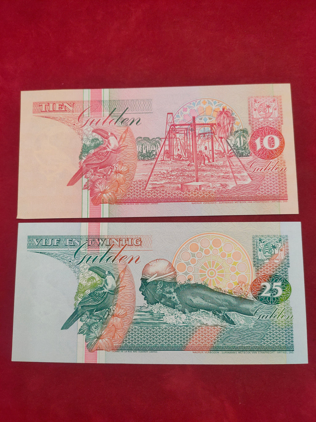 CENTRAL BANK OF SURINAME 10, 25 GULDEN (C409)